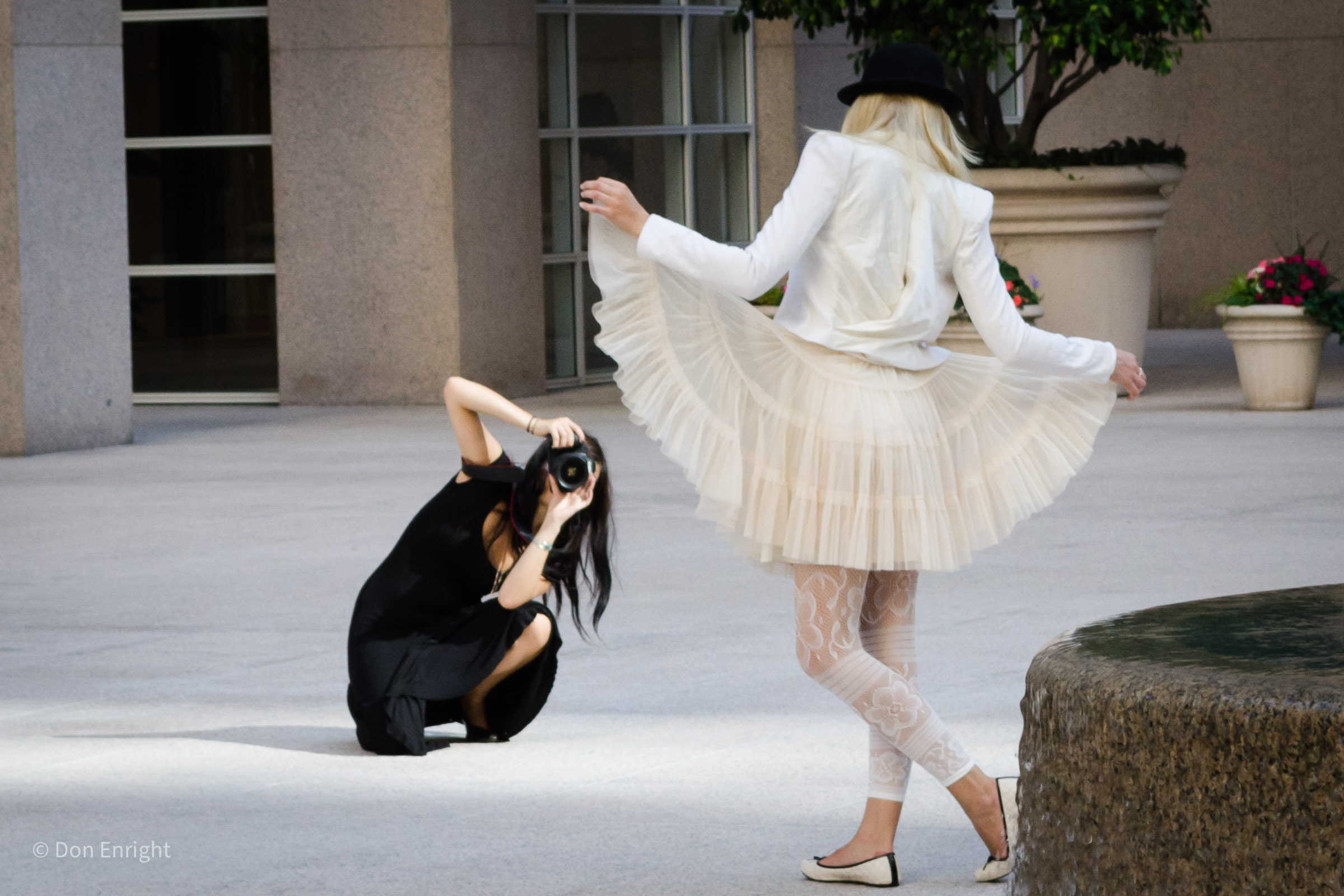 Photographer and fashion model in street.